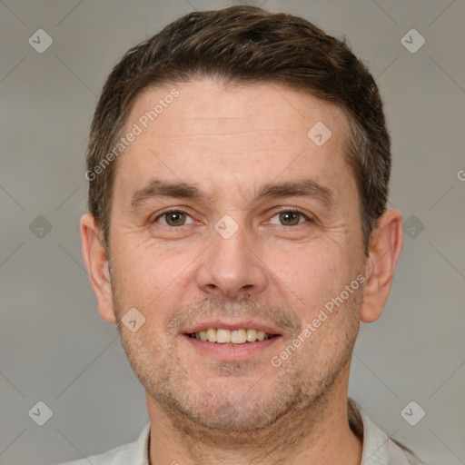 Joyful white adult male with short  brown hair and brown eyes