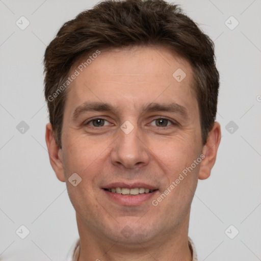 Joyful white adult male with short  brown hair and grey eyes