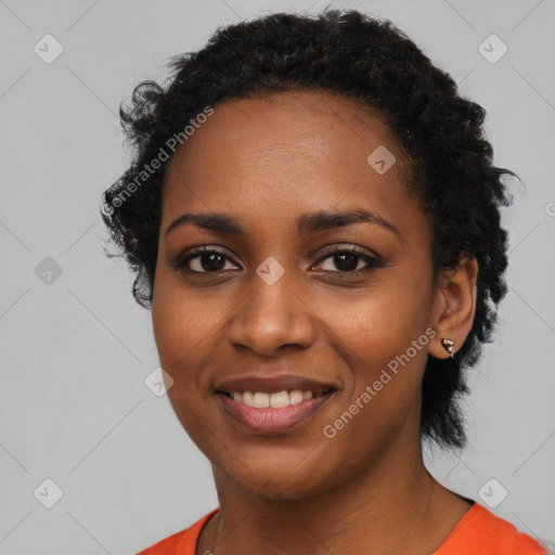 Joyful black young-adult female with short  black hair and brown eyes