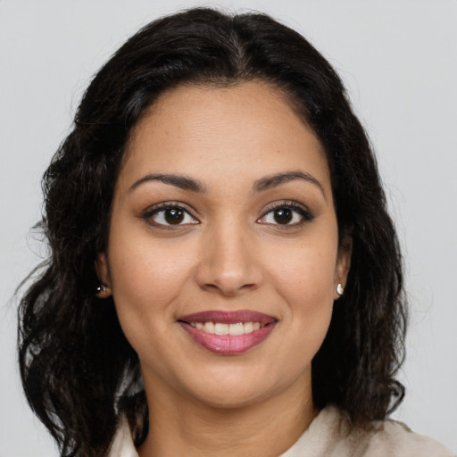 Joyful latino young-adult female with medium  brown hair and brown eyes