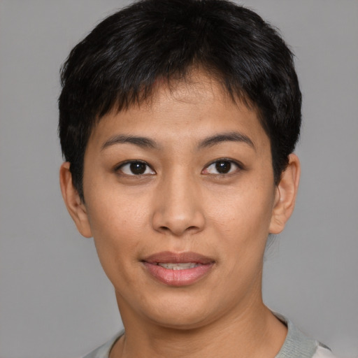 Joyful asian young-adult female with short  brown hair and brown eyes