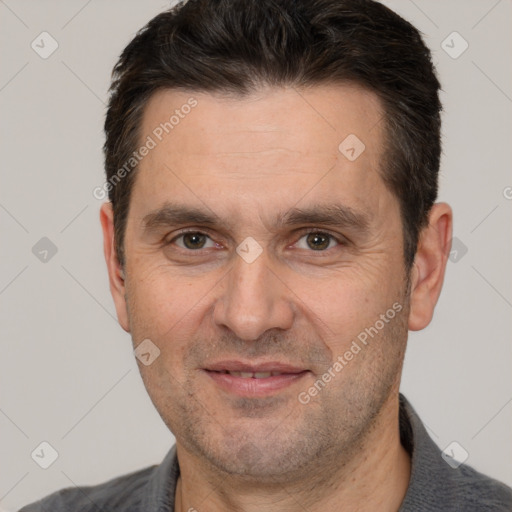 Joyful white adult male with short  brown hair and brown eyes