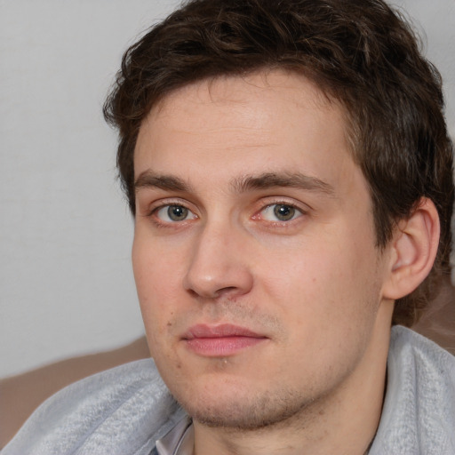 Joyful white young-adult male with medium  brown hair and brown eyes