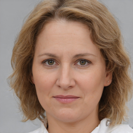 Joyful white adult female with medium  brown hair and brown eyes