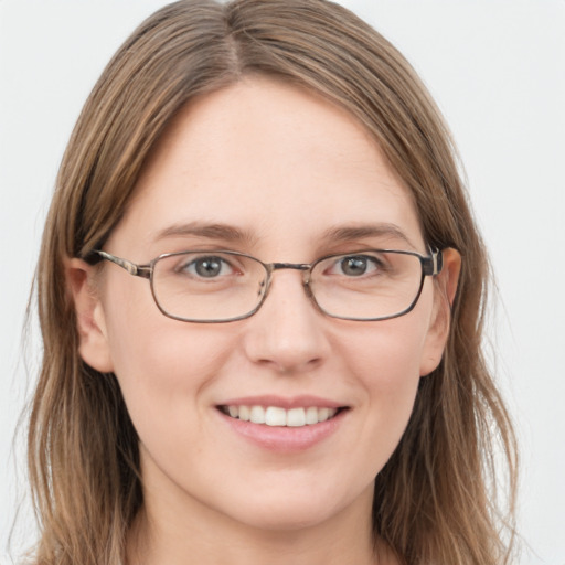 Joyful white young-adult female with long  brown hair and grey eyes