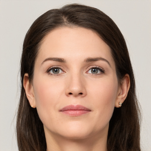 Joyful white young-adult female with long  brown hair and grey eyes