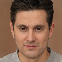 Joyful white adult male with short  brown hair and brown eyes