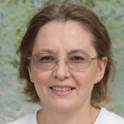 Joyful white adult female with medium  brown hair and grey eyes