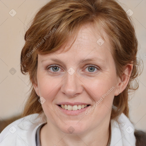 Joyful white adult female with medium  brown hair and blue eyes