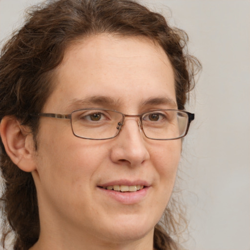 Joyful white adult female with medium  brown hair and green eyes