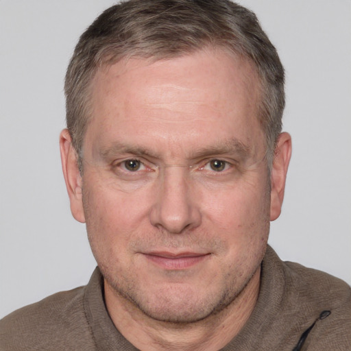 Joyful white adult male with short  brown hair and grey eyes