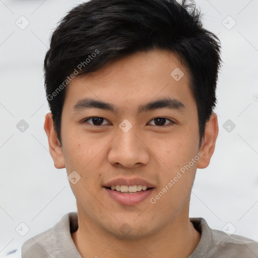 Joyful asian young-adult male with short  brown hair and brown eyes