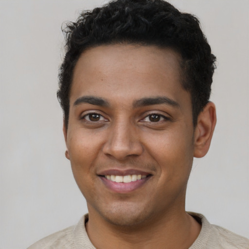 Joyful latino young-adult male with short  brown hair and brown eyes