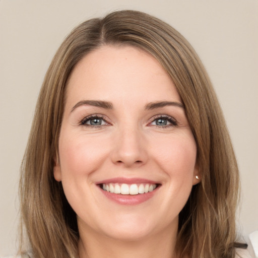 Joyful white young-adult female with long  brown hair and brown eyes