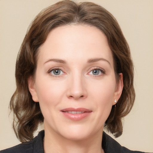 Joyful white adult female with medium  brown hair and grey eyes