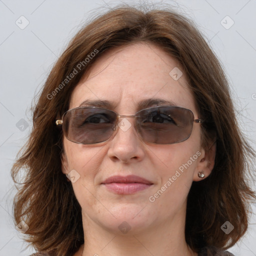 Joyful white adult female with medium  brown hair and blue eyes