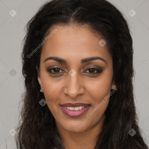 Joyful black young-adult female with long  brown hair and brown eyes