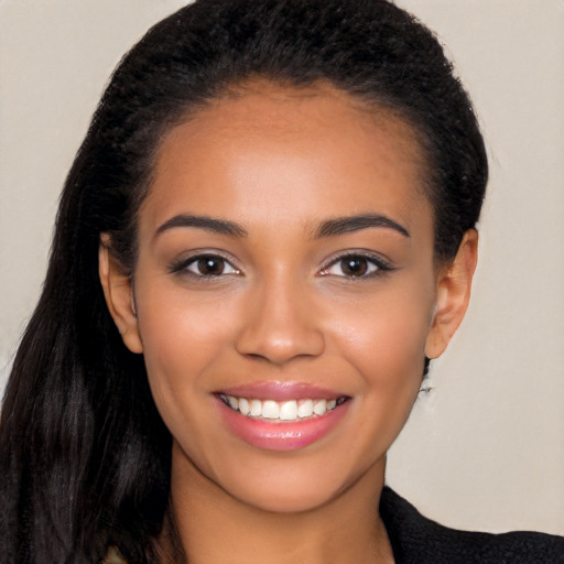 Joyful latino young-adult female with long  black hair and brown eyes