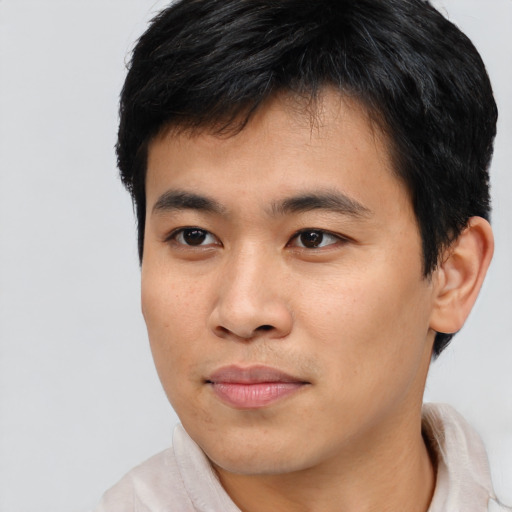 Joyful asian young-adult male with short  brown hair and brown eyes