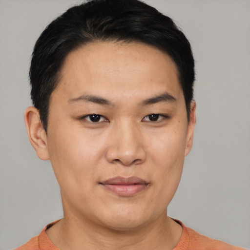 Joyful asian young-adult male with short  black hair and brown eyes