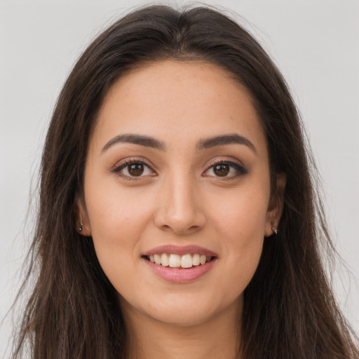 Joyful white young-adult female with long  brown hair and brown eyes