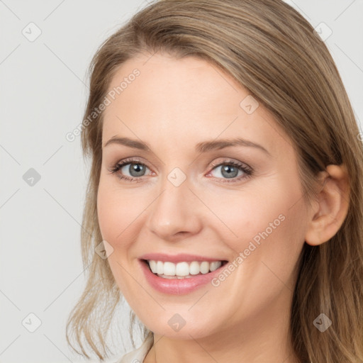 Joyful white young-adult female with long  brown hair and blue eyes