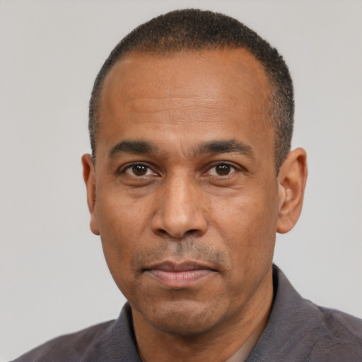 Neutral latino adult male with short  black hair and brown eyes