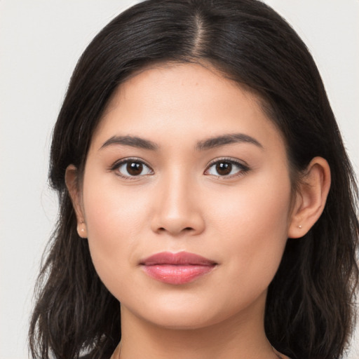 Joyful asian young-adult female with long  brown hair and brown eyes