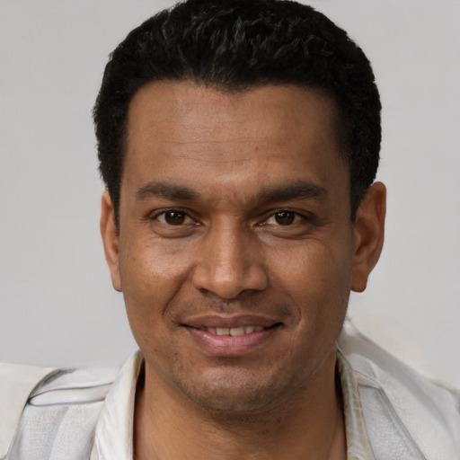 Joyful latino young-adult male with short  brown hair and brown eyes