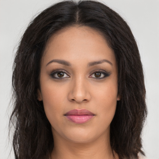 Joyful latino young-adult female with long  brown hair and brown eyes