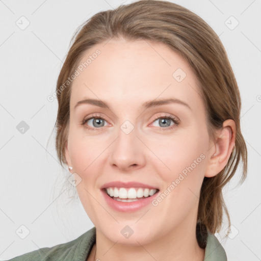 Joyful white young-adult female with medium  brown hair and green eyes