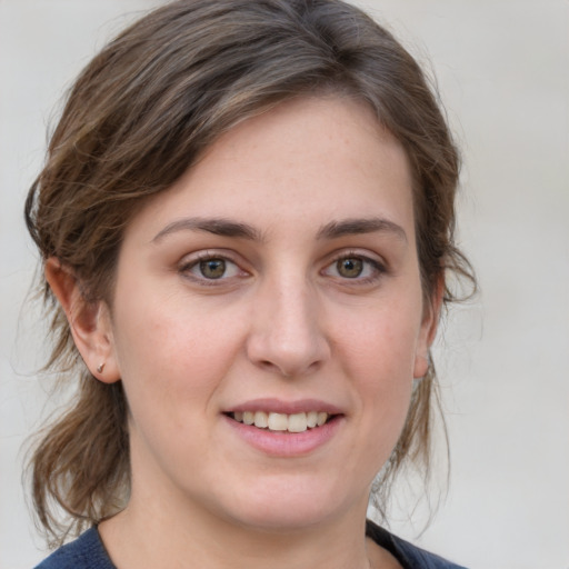 Joyful white young-adult female with medium  brown hair and grey eyes