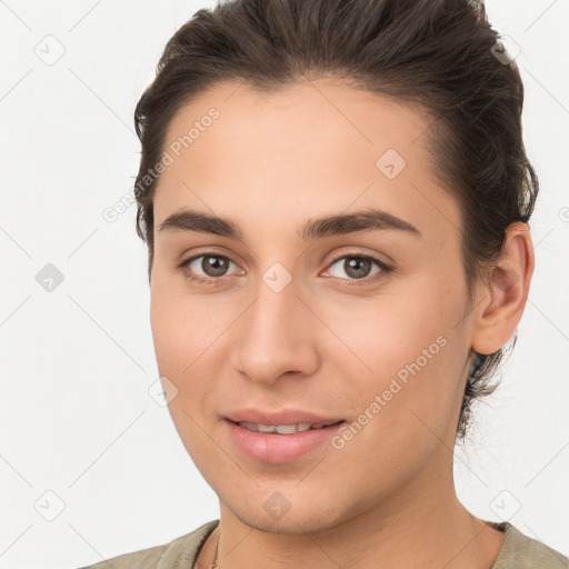 Joyful white young-adult female with short  brown hair and brown eyes