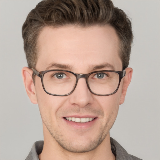 Joyful white adult male with short  brown hair and grey eyes