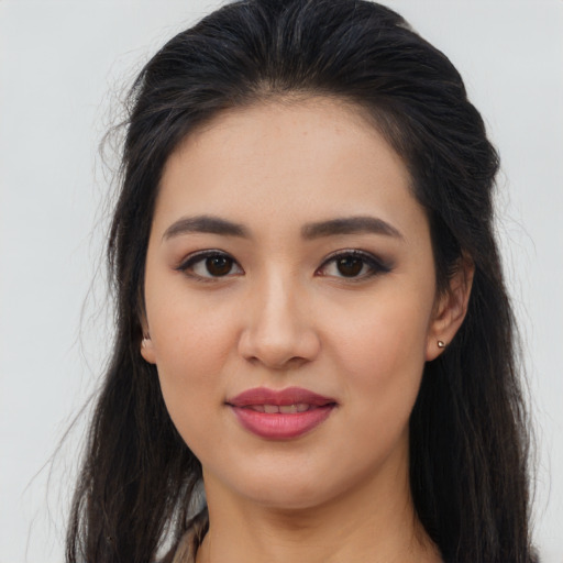 Joyful asian young-adult female with long  brown hair and brown eyes