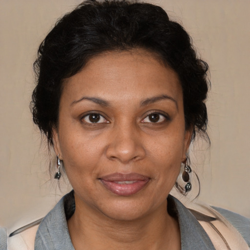 Joyful black adult female with medium  brown hair and brown eyes