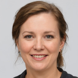 Joyful white adult female with medium  brown hair and grey eyes