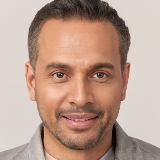 Joyful white adult male with short  brown hair and brown eyes