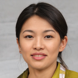 Joyful asian young-adult female with medium  brown hair and brown eyes