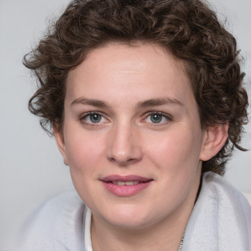 Joyful white young-adult female with medium  brown hair and blue eyes