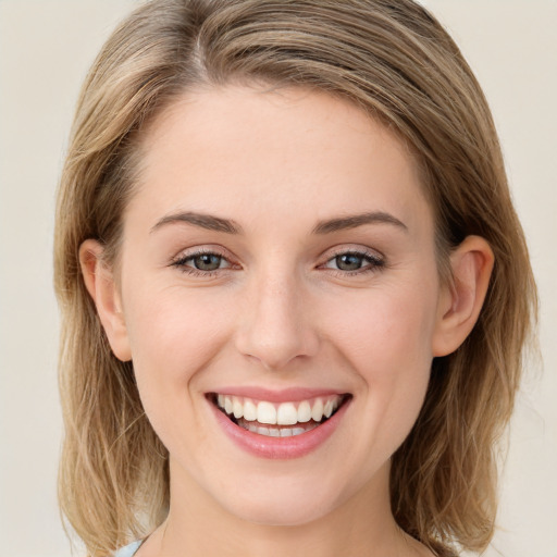 Joyful white young-adult female with long  brown hair and green eyes