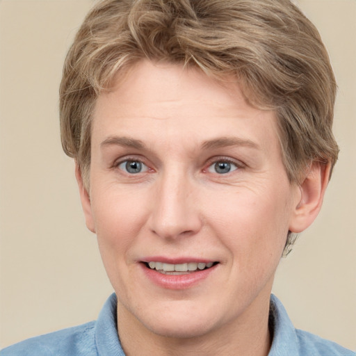 Joyful white adult female with short  brown hair and grey eyes