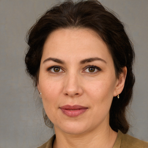 Joyful white adult female with medium  brown hair and brown eyes