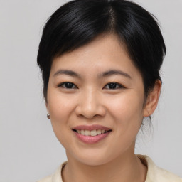 Joyful asian young-adult female with medium  black hair and brown eyes