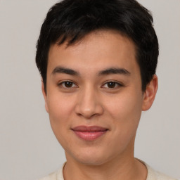 Joyful latino young-adult male with short  brown hair and brown eyes