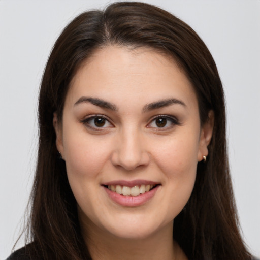 Joyful white young-adult female with long  brown hair and brown eyes