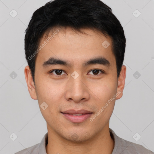 Joyful asian young-adult male with short  black hair and brown eyes