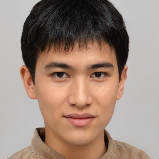 Joyful asian young-adult male with short  brown hair and brown eyes