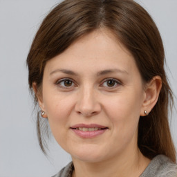 Joyful white adult female with medium  brown hair and brown eyes