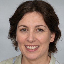 Joyful white adult female with medium  brown hair and brown eyes